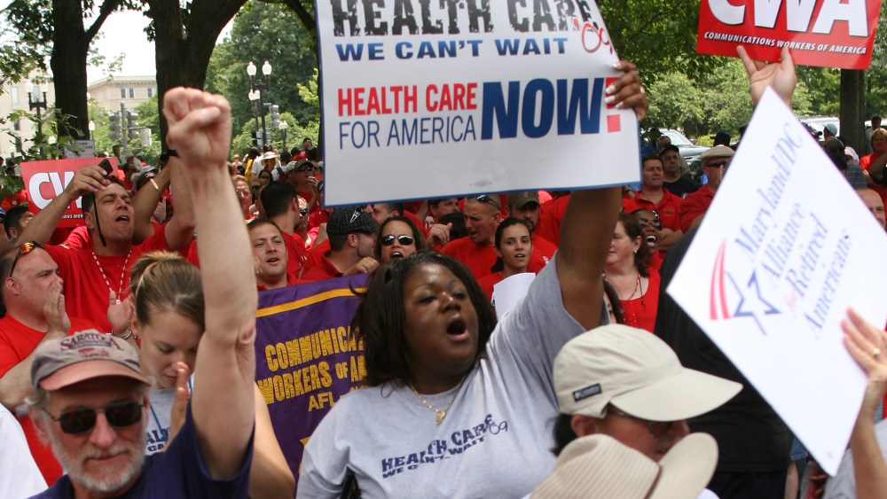 People march during a rally for affordable health care June 25, 2009 on Capitol Hill in Washington, D.C.