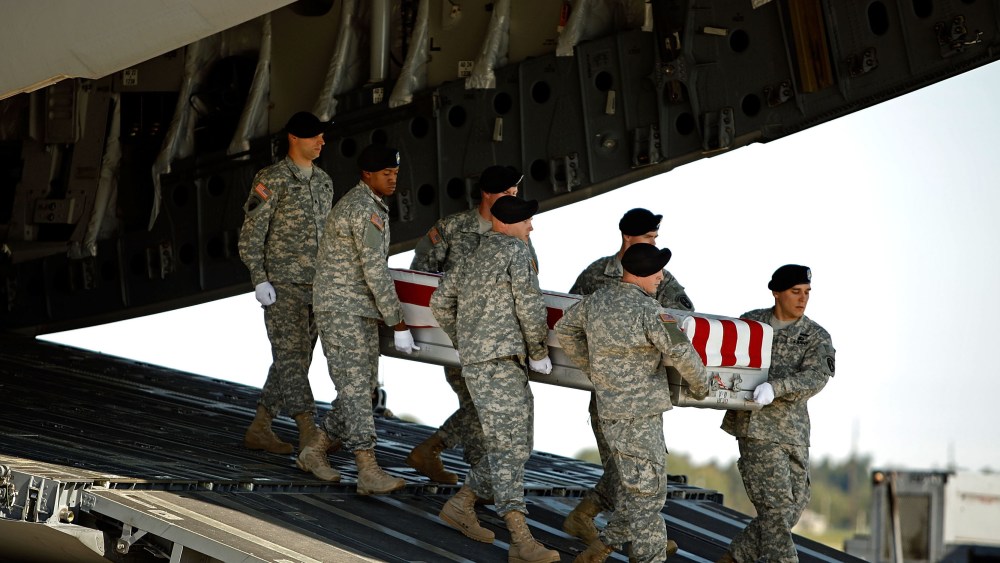 File Photo: U.S. Army soldiers carry the flag-draped transfer case containing the remains of U.S. Army Sergeant Vernon W. Martin of Savannah, Georgia, out of a C-17 during a dignified transfer on the tarmac at Dover Air Force Base October 6, 2009 in...