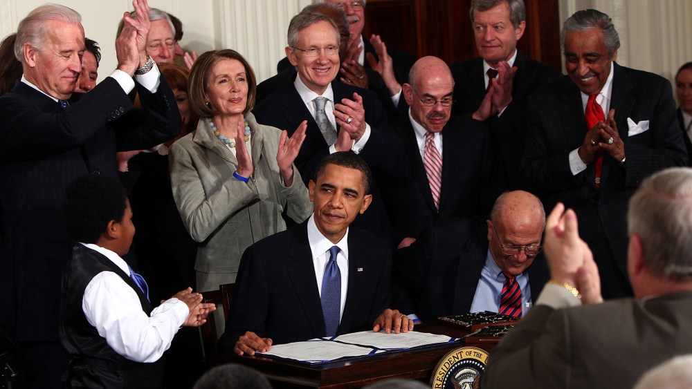 President Barack Obama is applauded after signing the Affordable Health Care for America Act during a ceremony with fellow Democrats in the East Room of the White House March 23, 2010 in Washington, DC. (Photo by Win McNamee/Getty)