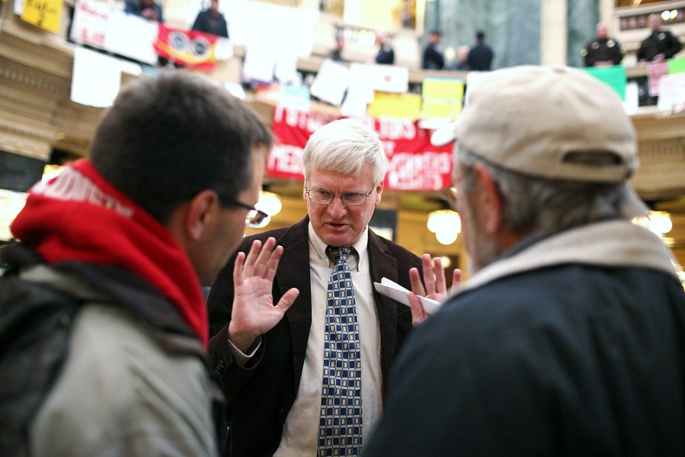 Republican Wisconsin State Senator Glenn Grothman (C) talks with Mark Dziedzic (L) and Jeff Dziedzic inside the Wisconsin State Capitol on March 4, 2011 in Madison, Wisconsin.