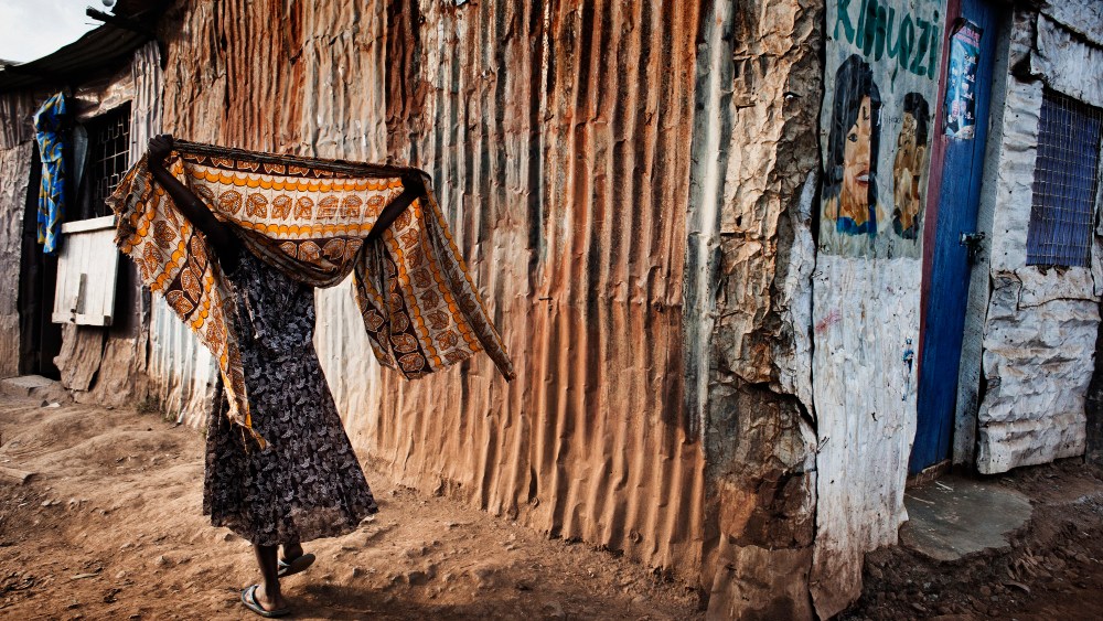 A woman covers her head with a shawl.