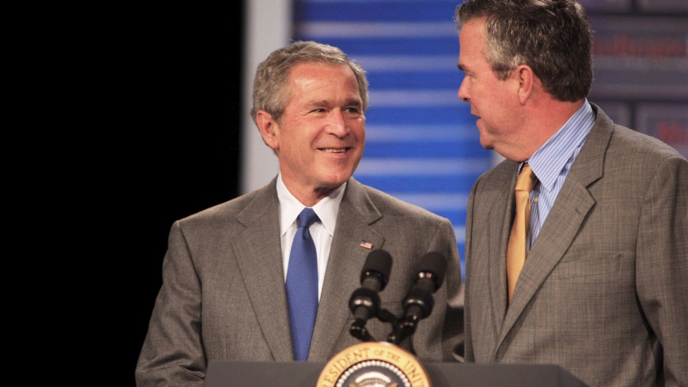 President George W. Bush (L) smiles at his brother Florida Governor Jeb Bush before making remarks at an event in Sun City Center, Fla., on March 8, 2006. (Photo by Chris Livingston/EPA)