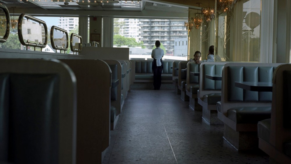 A waitress looks out the window of a diner in Fort Lee, N.J. (Photo by Kelly Shimoda/Redux)