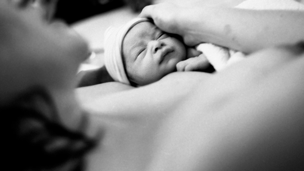A mother holding a baby.