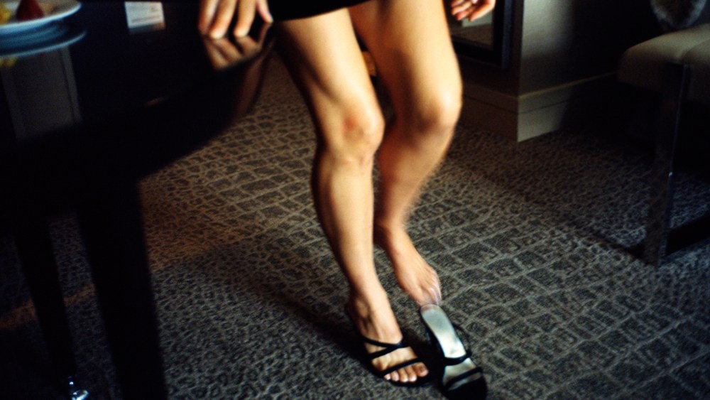 An escort slips into a high heel shoe in Washington D.C.