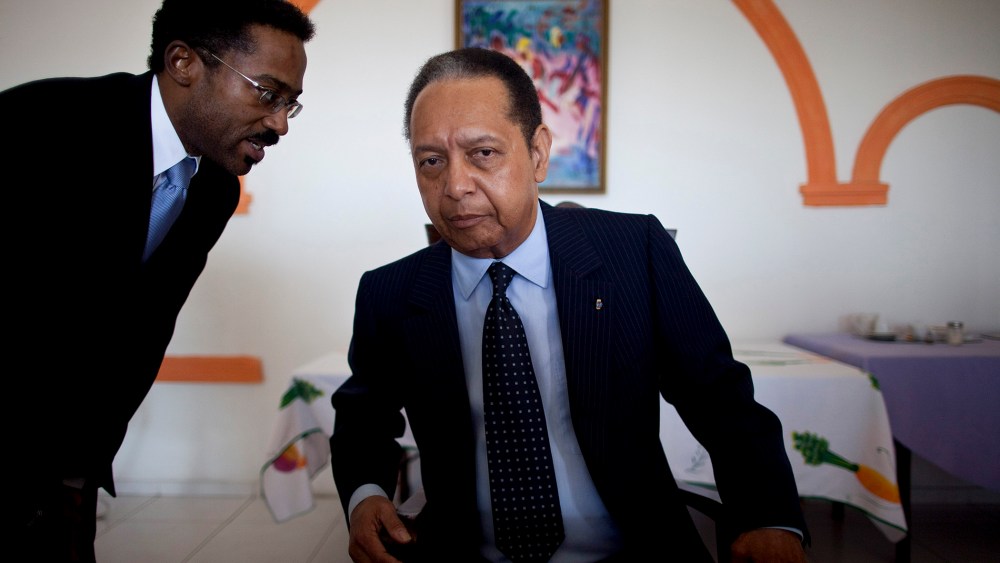 Jean-Claude Duvalier, right, Haiti's former dictator known as Baby Doc, listens to a translator during a meeting, in Port-au-Prince, Haiti, Jan. 24, 2011.
