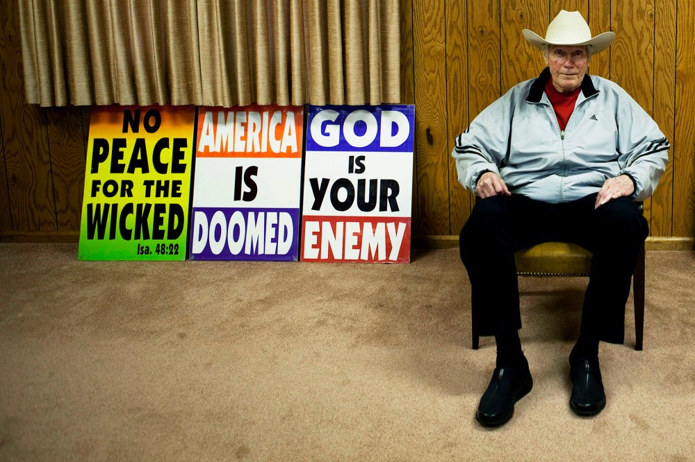 Fred W. Phelps Sr., of Westboro Baptist Church, pictured with picket signs at Westboro Church in Topeka, Kansas, Sept. 8, 2010.