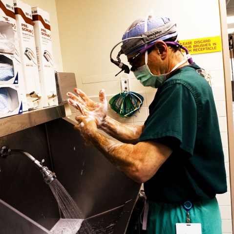 A doctor washes his hands just moments before his heart transplant surgery is set to begin at a hospital in the Bronx, New York City.