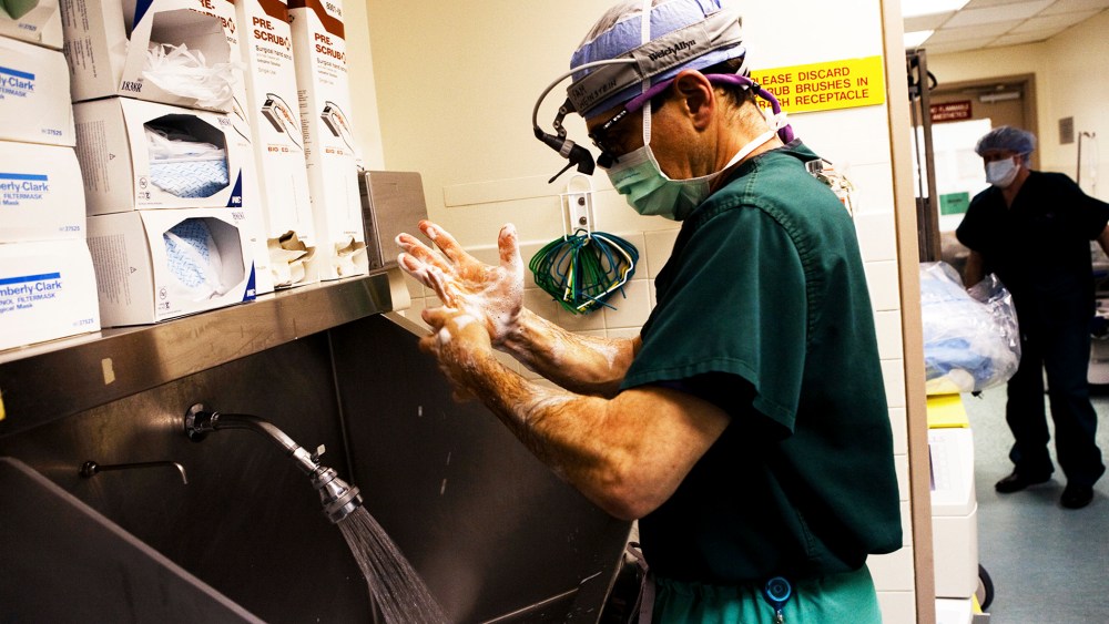 A doctor washes his hands just moments before his heart transplant surgery is set to begin at a hospital in the Bronx, New York City.