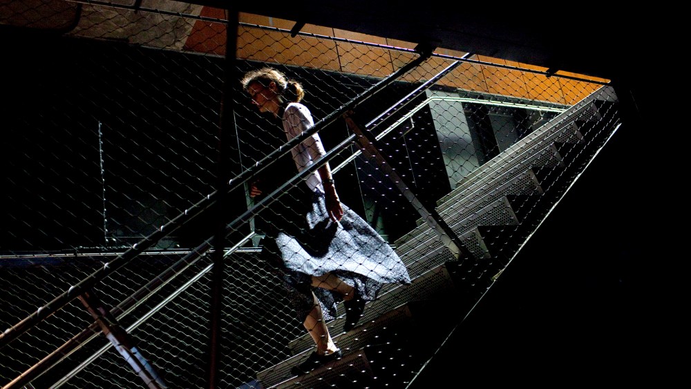 A walks on a stairway at the High Line Park in New York City.