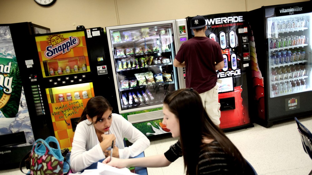 A student selects baked potato chips from a vending machine at Commack High School in Commack, N.Y., Sept. 19, 2011.