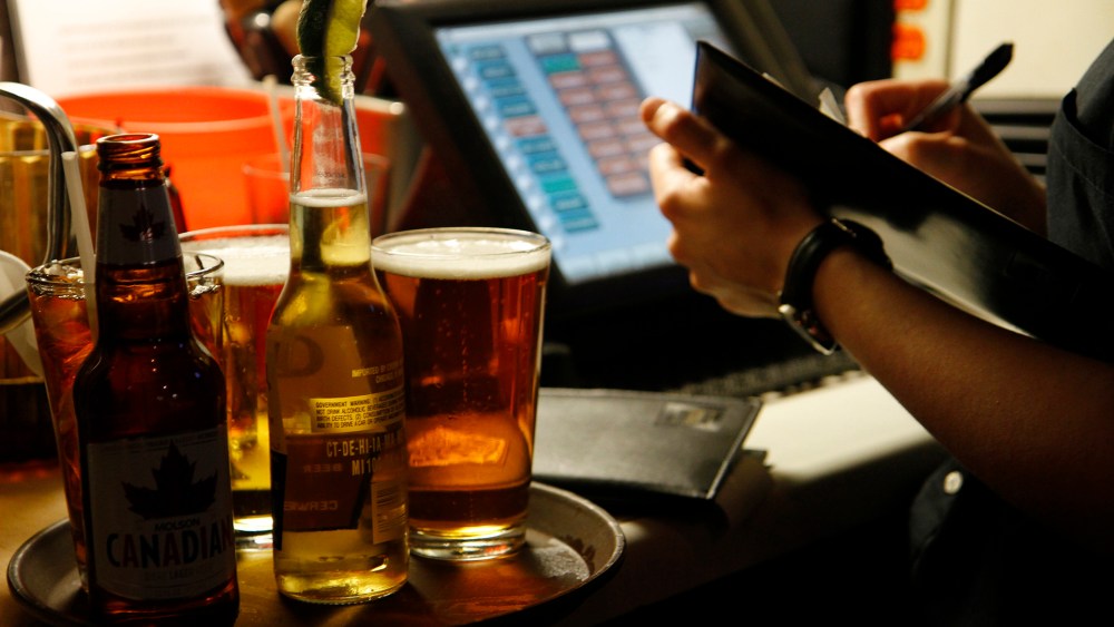 A server at a restaurant in Boston, Mass. (Photo by Mark Peterson/Redux)