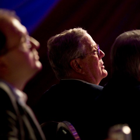 David Koch listens to Mitt Romney speak in Washington on Nov. 4, 2011.