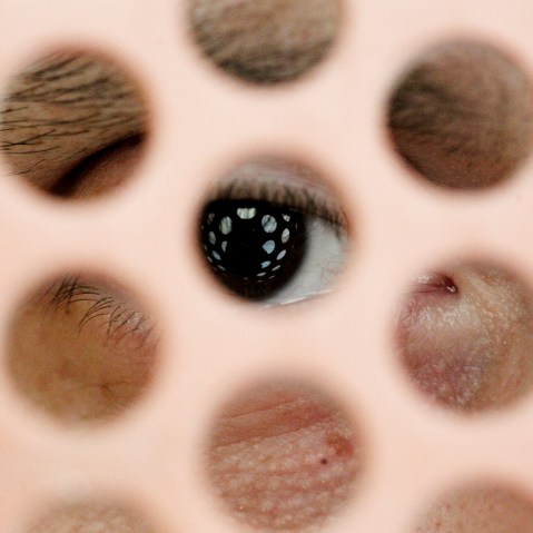 An inmate at Pelican Bay State Prison looks out from the grates of his cell, in 2012.