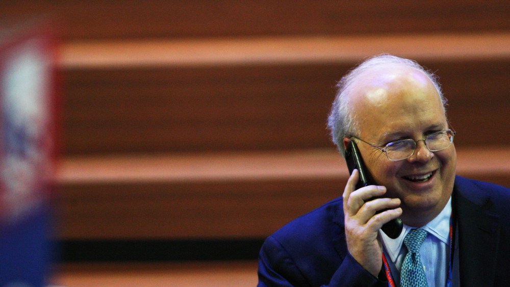 Karl Rove speaks on a cellphone during the Republican National Convention at the Tampa Bay Times Forum.