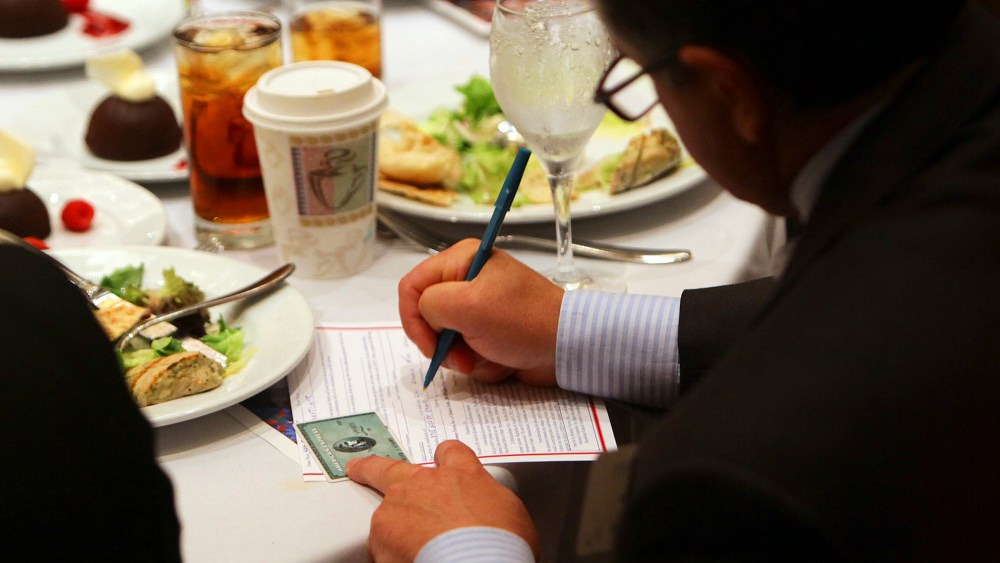 An attendee makes an additional donation during a fundraiser in Atlanta on Sept. 19, 2012.