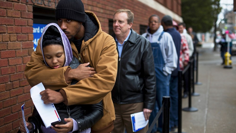 Mykia Eubanks and Jay Gwinn wait in line to vote early in downtown Cincinnati.