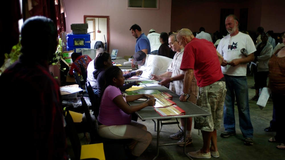 Voters line up to show identification before casting ballots at Deliverance Tabernacle Church of the Nazarene in Miami.