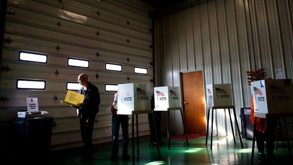 Voters cast ballots at a polling station at Ray Lounsberry's shed in Nevada Township, Iowa on Election Day, Nov. 6, 2012