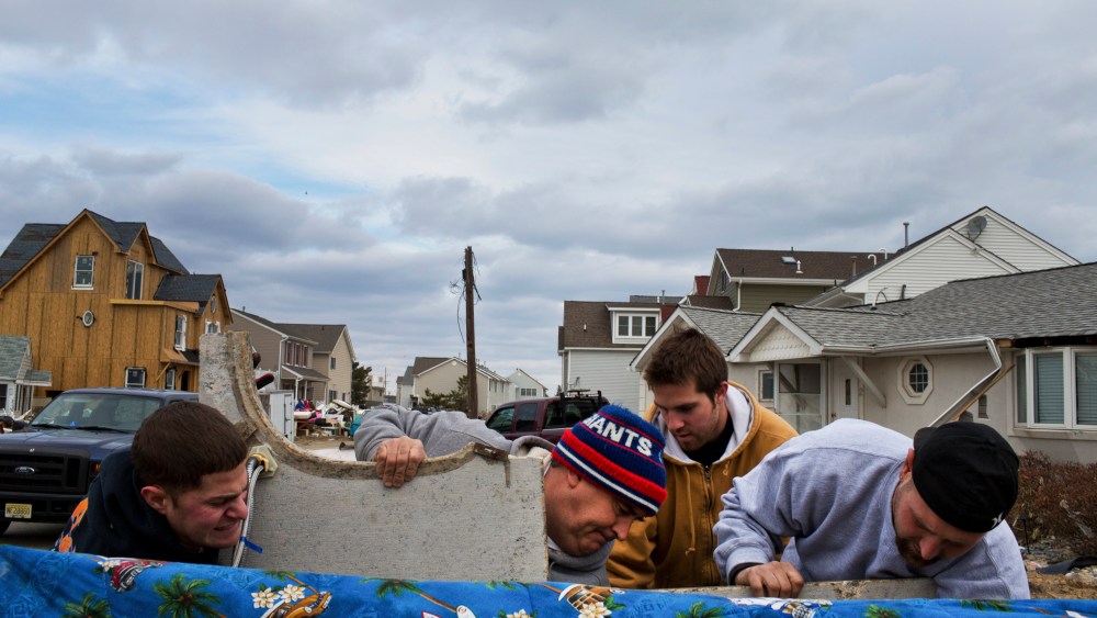 Residents of Ortley Beach, N.J. remove debris after returning for the first time since Hurricane Sandy pulverized the area, Nov. 25, 2012.