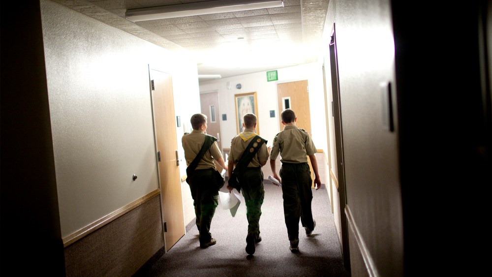 Boy scouts walk through the empty halls of a meeting house of the Church of Jesus Christ of Latter-day Saints, in Cedar Hills, Utah, Oct. 11, 2012.