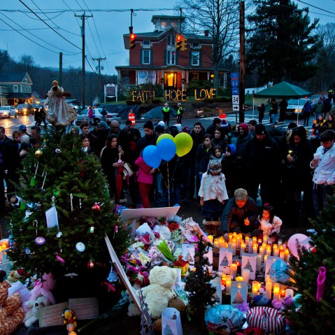 People gather and mourn at makeshift memorial set up around Newtown, Conn. on Dec. 16, 2012 for the victims of the shootings at Sandy Hook Elementary School. (Photo by Mark Peterson/Redux)