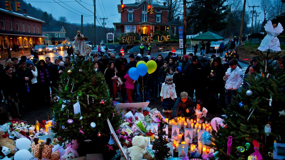 People gather and mourn at makeshift memorial set up around Newtown, Conn. on Dec. 16, 2012 for the victims of the shootings at Sandy Hook Elementary School. (Photo by Mark Peterson/Redux)