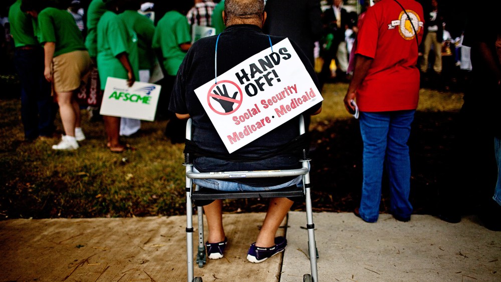 A protester listens at the rally outside the Social Security Administration offices in Baltimore, Maryland, July 25, 2011.