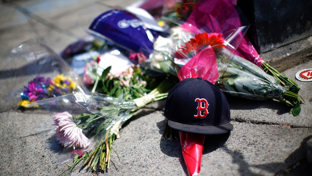 A makeshift memorial on the sidewalk on Newbury Street near the site of two bomb explosions that occurred during the Boston Marathon, April 18, 2013.