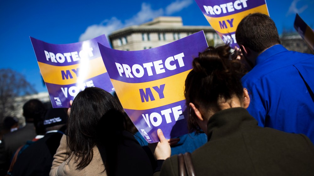 Protestors gather outside of the U.S. Supreme Court in support of Section 5 of the Voting Rights Act of 1965, in Washington, Feb. 27, 2013.