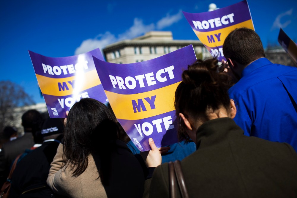 Protestors gather outside of the U.S. Supreme Court in support of Section 5 of the Voting Rights Act of 1965, in Washington, Feb. 27, 2013.