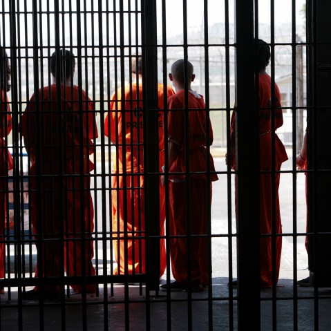 Inmates wait to be transported for medical screening after arriving at the California Institution for Men in Chino, Calif.