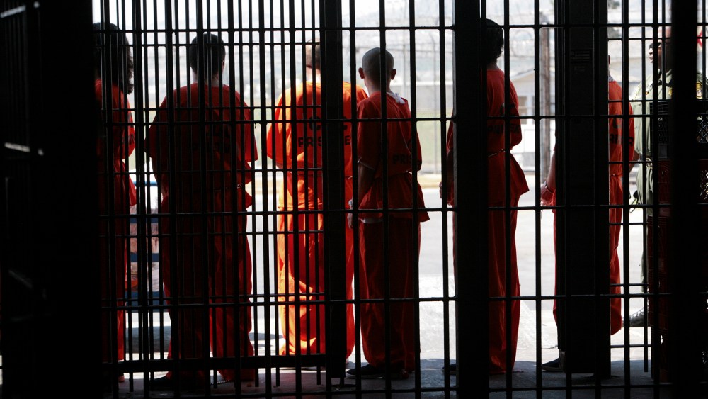 Inmates wait to be transported for medical screening after arriving at the California Institution for Men in Chino, Calif.