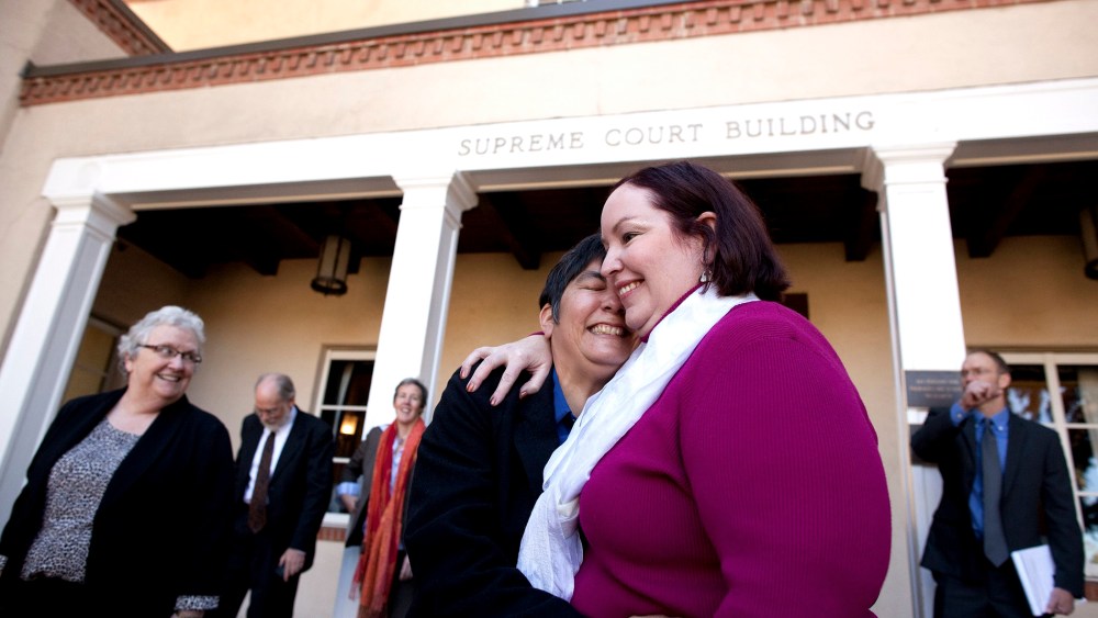 Plaintiffs Rose Griego, left, and Kim Kiel hug outside the New Mexico Supreme following a hearing on same-sex marriage in Santa Fe, N.M., Oct. 23, 2013.