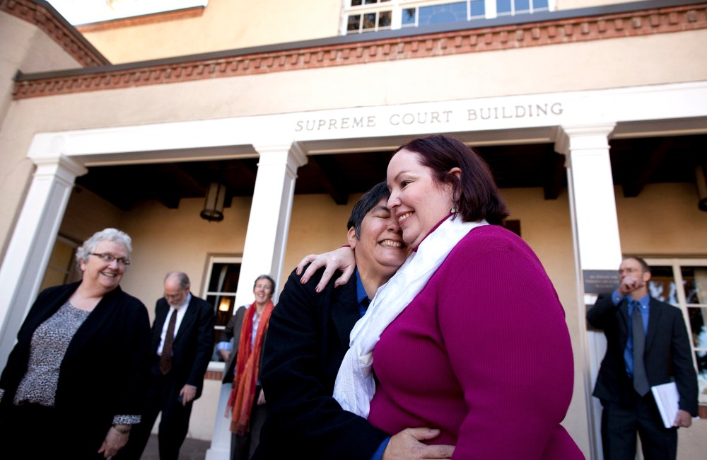 Plaintiffs Rose Griego, left, and Kim Kiel hug outside the New Mexico Supreme following a hearing on same-sex marriage in Santa Fe, N.M., Oct. 23, 2013.