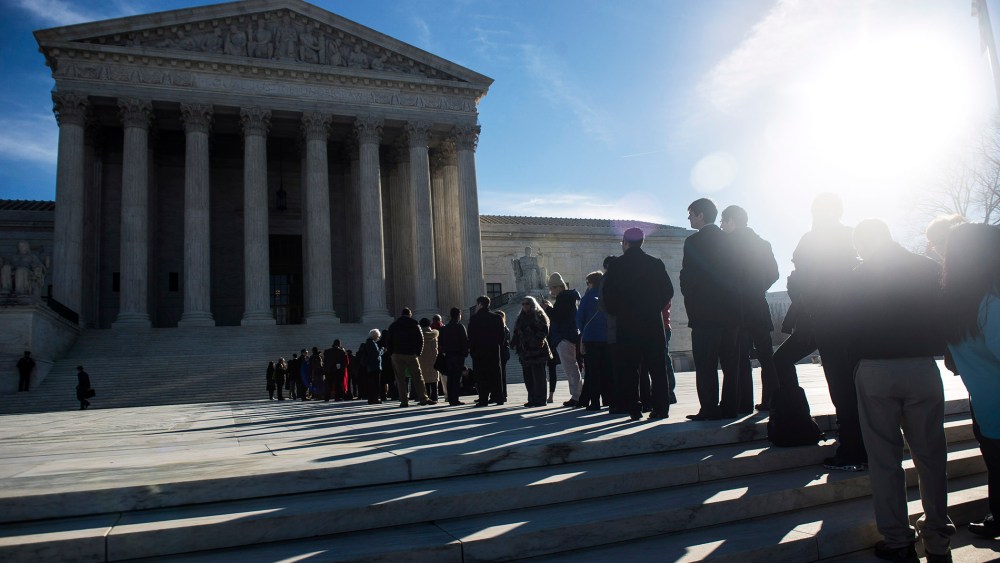 People wait in line to enter the U.S. Supreme Court on the first day of January sessions in Washington, Jan. 13, 2014.