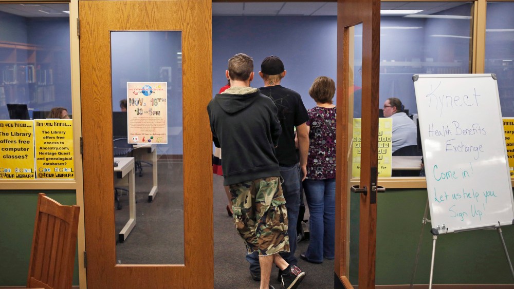 Attendees line up at an Affordable Care Act open enrollment event at a public library in LaGrange, Ky., Oct. 21, 2013.