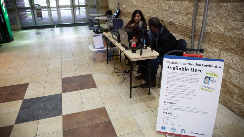 Department of Public Safety employees attend to a voter identification station in Houston. (Michael Stravato/The New York Times)