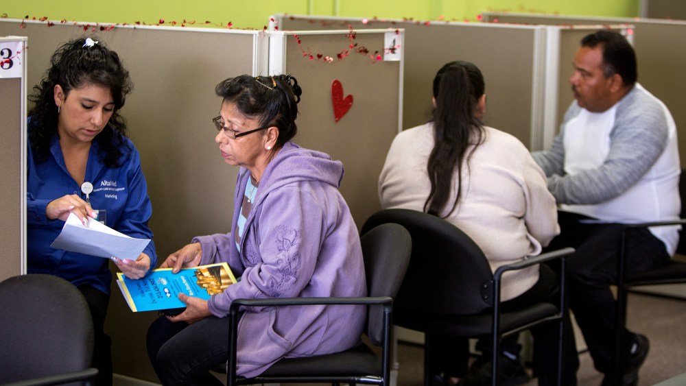 Jesica Arias, meets with clients at AltaMed Resource Center to guide them through applying for insurance under the Affordable Care Act in Commerce, Calif., Jan. 30, 2014.