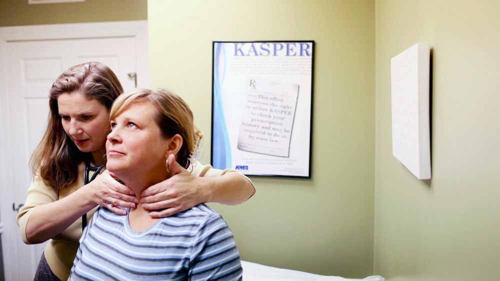 Dr. Tracy Ragland, a pediatrician and family practitioner, examines patient Kelli Van Zant at her private practice in Crestwood, Ky.