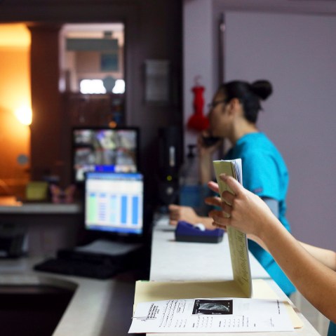 Medical assistant Nyla Munoz closes a walk-in patient's file at the Whole Women's Health Clinic in McAllen.