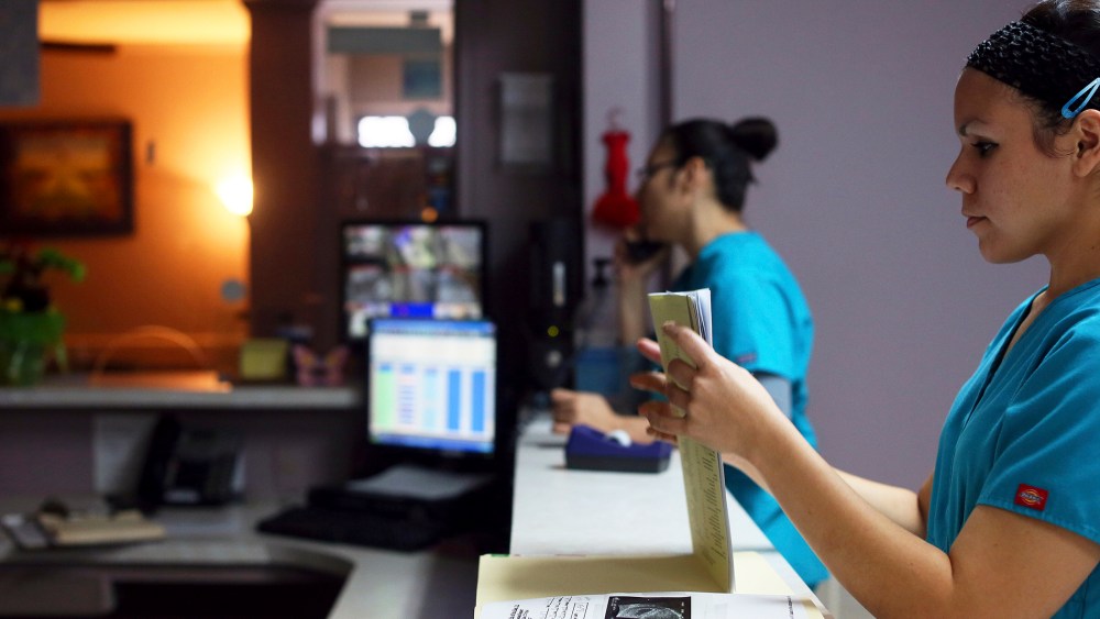 Medical assistant Nyla Munoz closes a walk-in patient's file at the Whole Women's Health Clinic in McAllen.