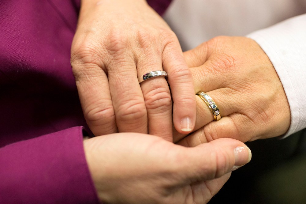 Jonnie Terry joins hands with her partner of 28 years, Elizabeth Patten, during their marriage ceremony at the Washtenaw County Clerk's Office in Ann Arbor, Mich., March 22, 2014.