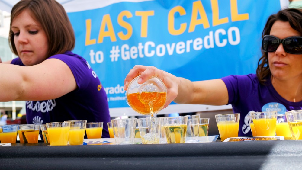 Workers pour juice as they promote health care coverage during a "Last Call" event in Denver, March 20, 2014.