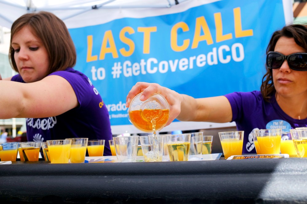 Workers pour juice as they promote health care coverage during a "Last Call" event in Denver, March 20, 2014.