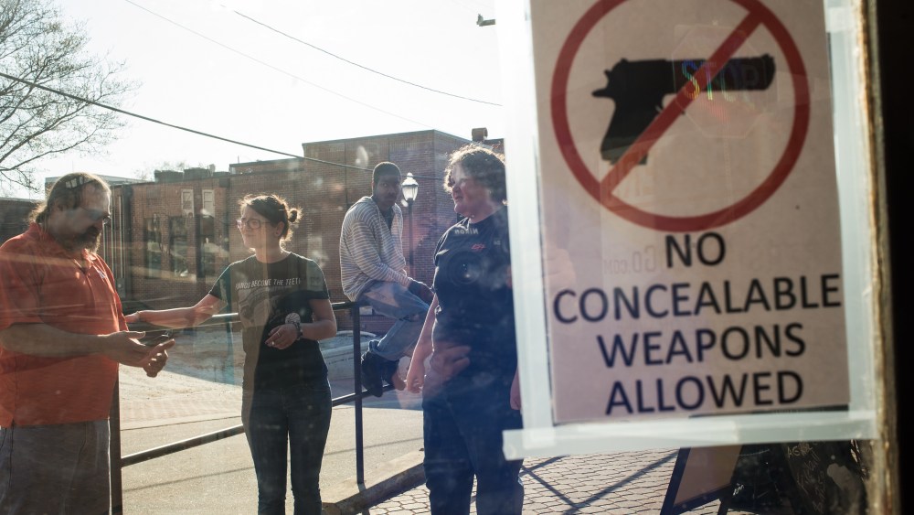 Pete Matsko, left, gathers with his staff outside the Backstreets Pub and Grill in Clemson, S.C.
