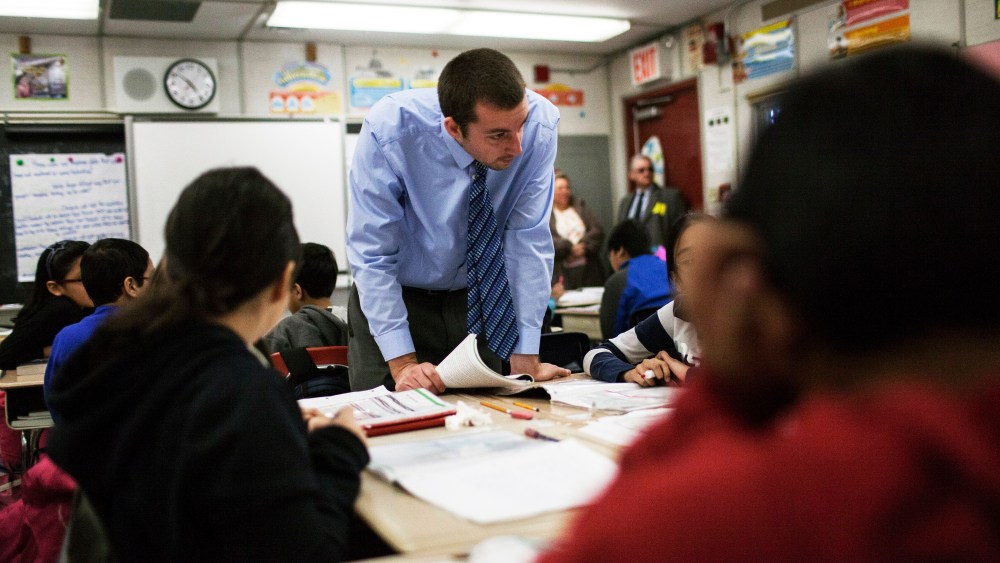A teacher with his fifth grade students at Woodside Intermediate School 125 in the Queens borough of New York, March 27, 2014.
