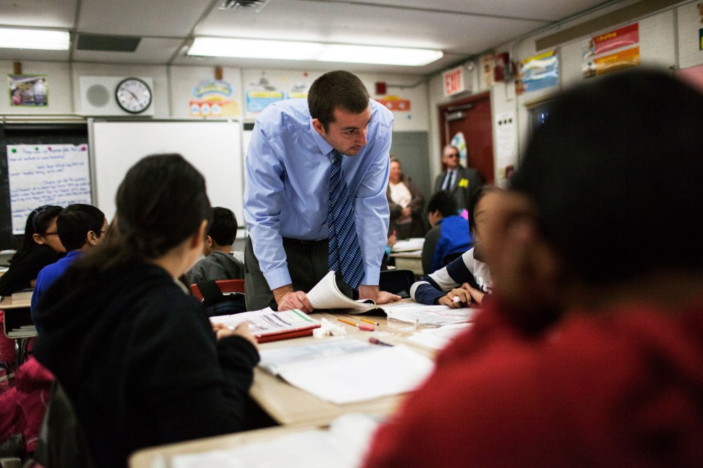 A teacher with his fifth grade students at Woodside Intermediate School 125 in the Queens borough of New York, March 27, 2014.