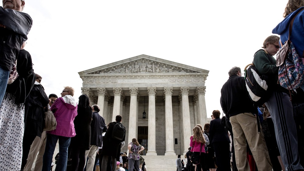 Members of the public wait in line to hear oral arguments at the Supreme Court in Washington.