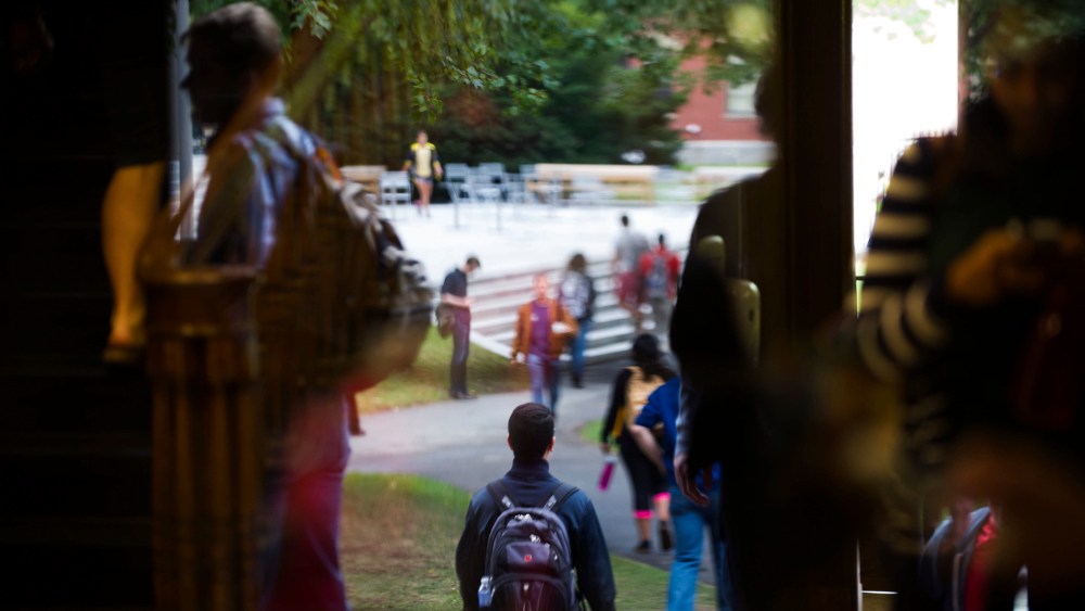 Harvard University students on their way about campus in Cambridge, Mass. (Photo by Gretchen Ertl/The New York Times/Redux)